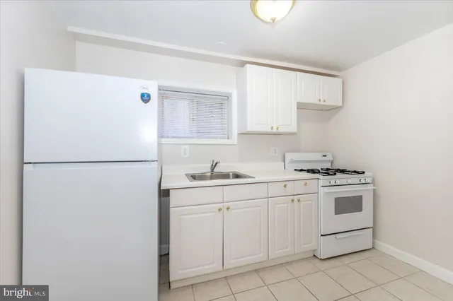 a bathroom with a toilet sink vanity and mirror
