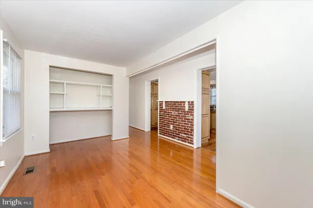 a view of wooden floor and windows in a room