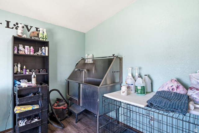 4296 Maple Lane Cedar City, UT 84721 - Photo 24 of 44 Dedicated utility room featuring a large stainless steel wash basin with integrated steps, wood-finish flooring, and light blue wall paint
