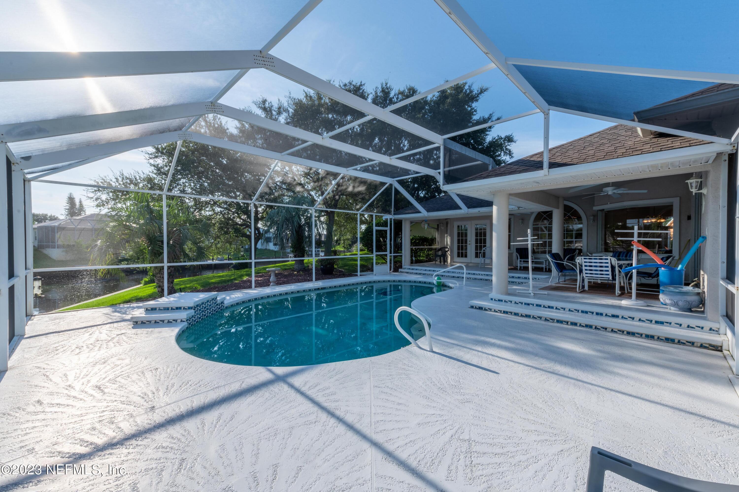 13 Clear Court Palm Coast, FL 32137 - Photo 11 of 60 a view of a backyard with swimming pool