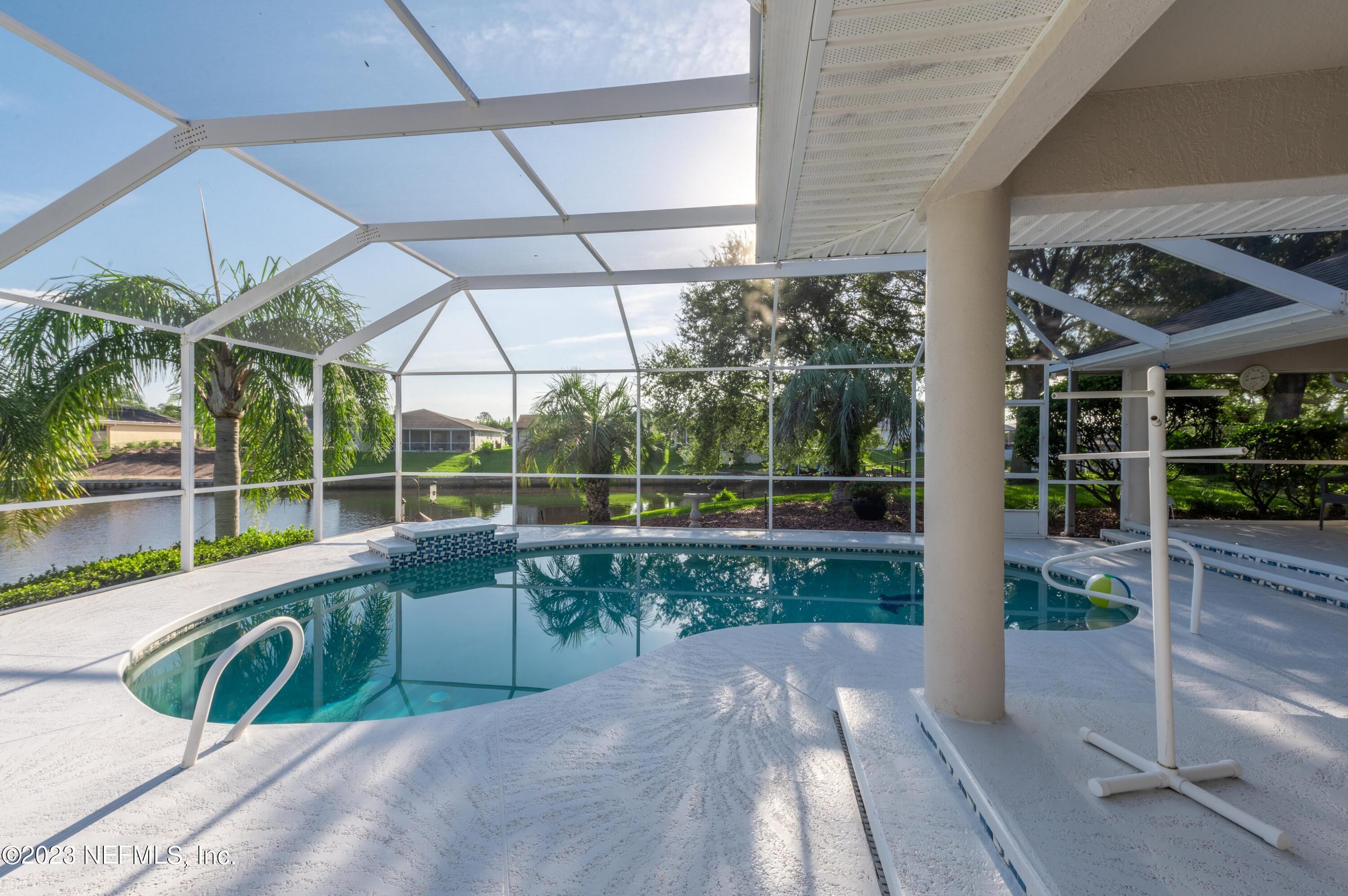 13 Clear Court Palm Coast, FL 32137 - Photo 12 of 60 a view of a small yard and a large tub