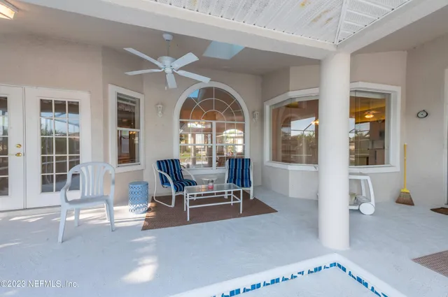 a view of a patio with table and chairs under an umbrella