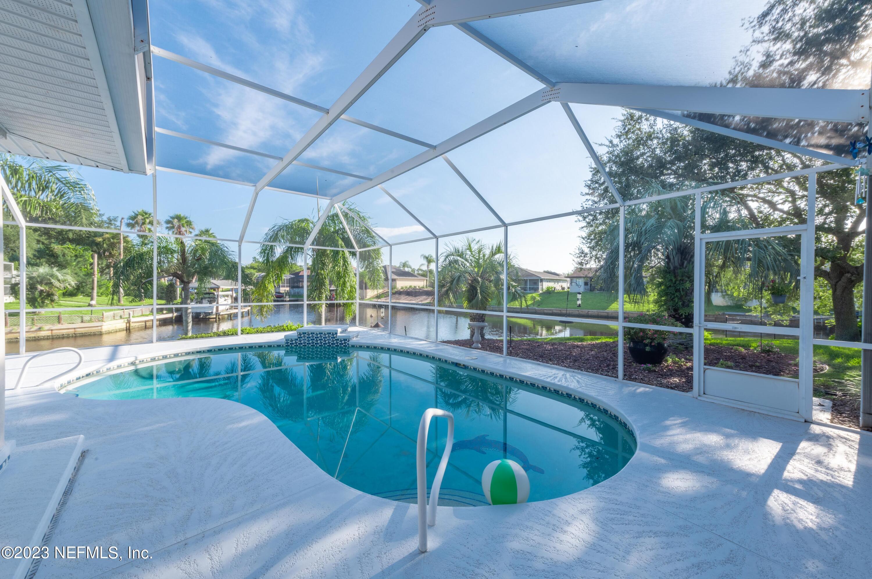 13 Clear Court Palm Coast, FL 32137 - Photo 15 of 60 a view of a swimming pool with a porch