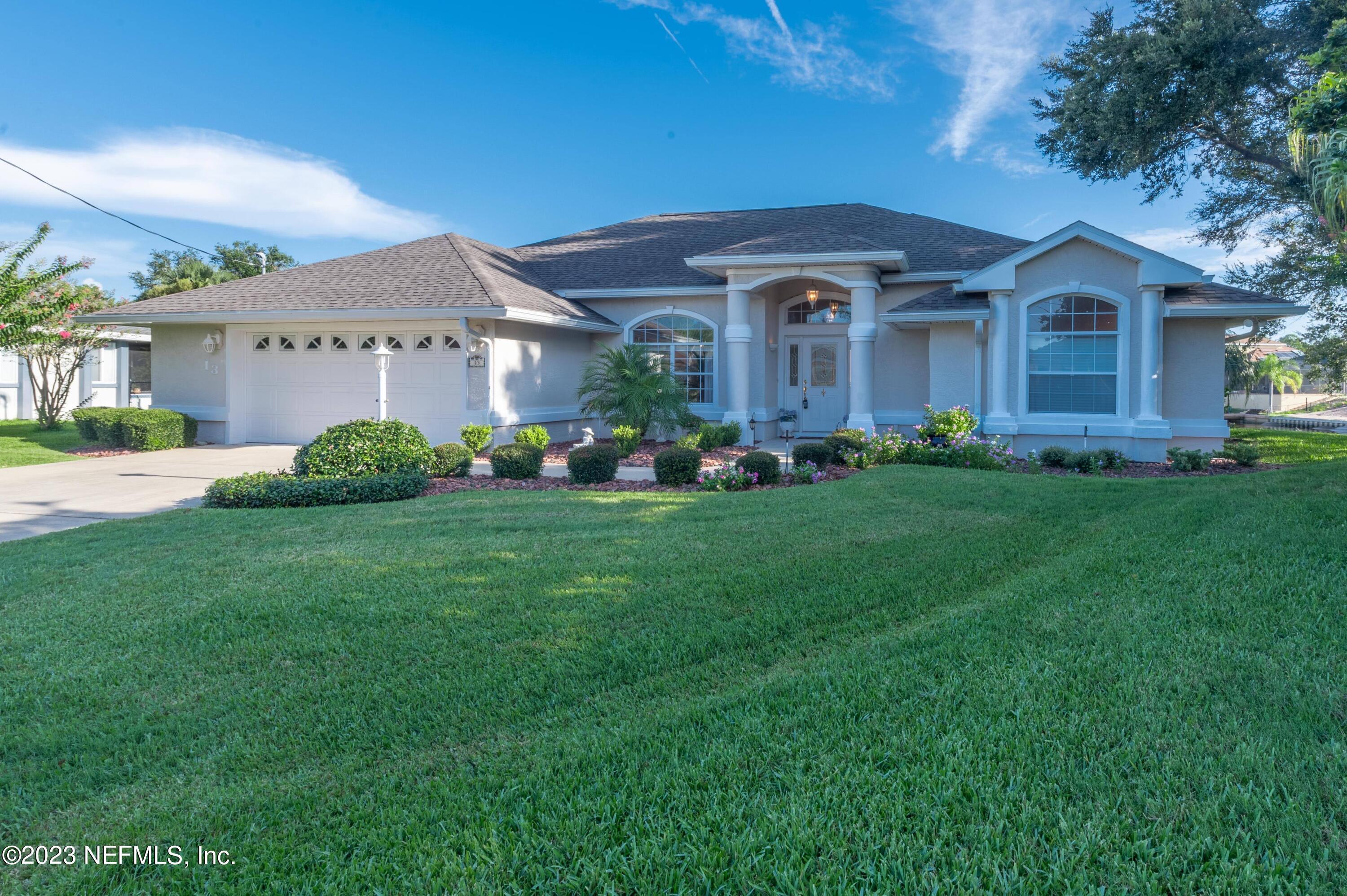 13 Clear Court Palm Coast, FL 32137 - Photo 2 of 60 a front view of a house with garden