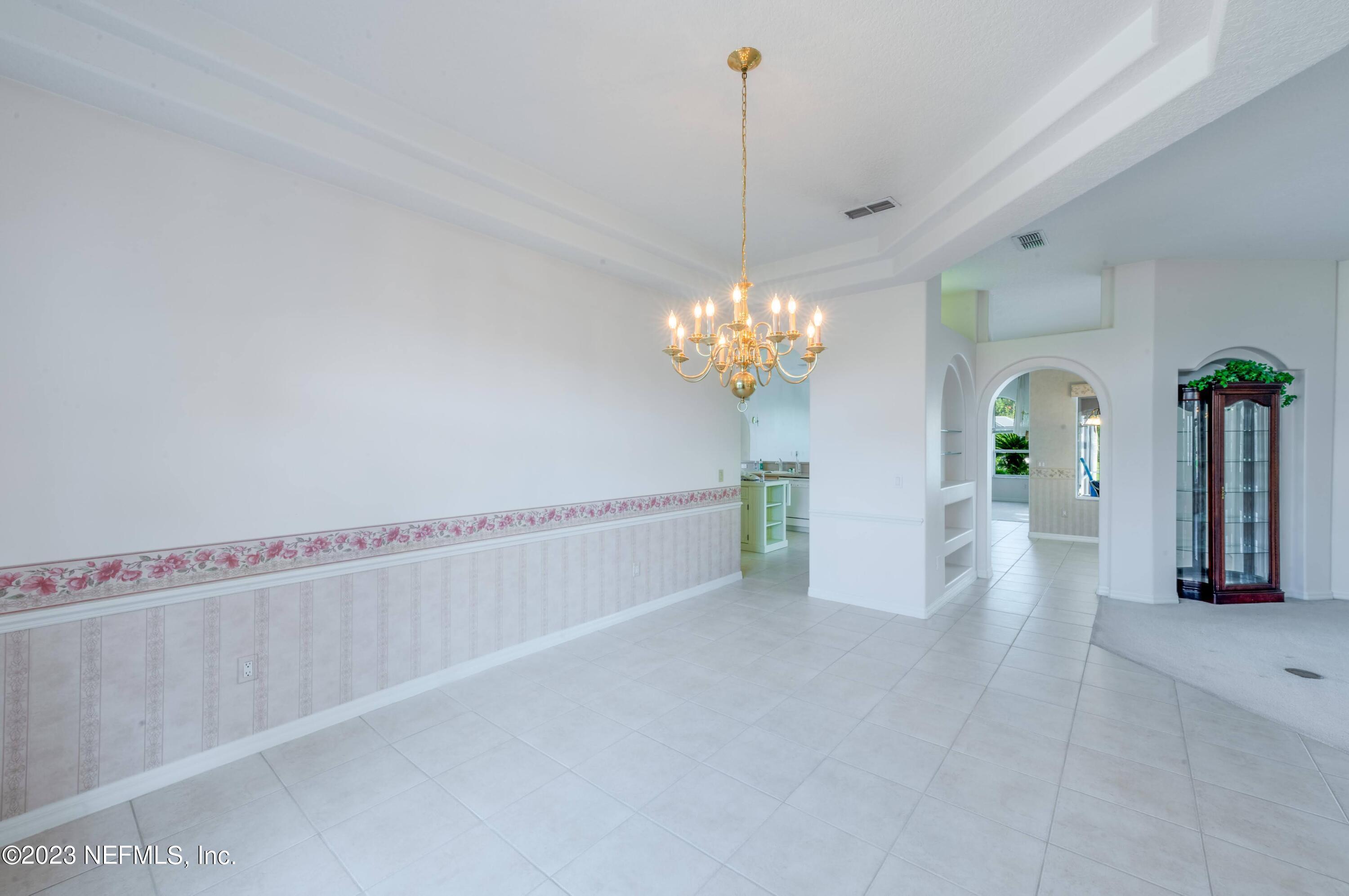 13 Clear Court Palm Coast, FL 32137 - Photo 23 of 60 a view of a chandelier and a chandelier in a room
