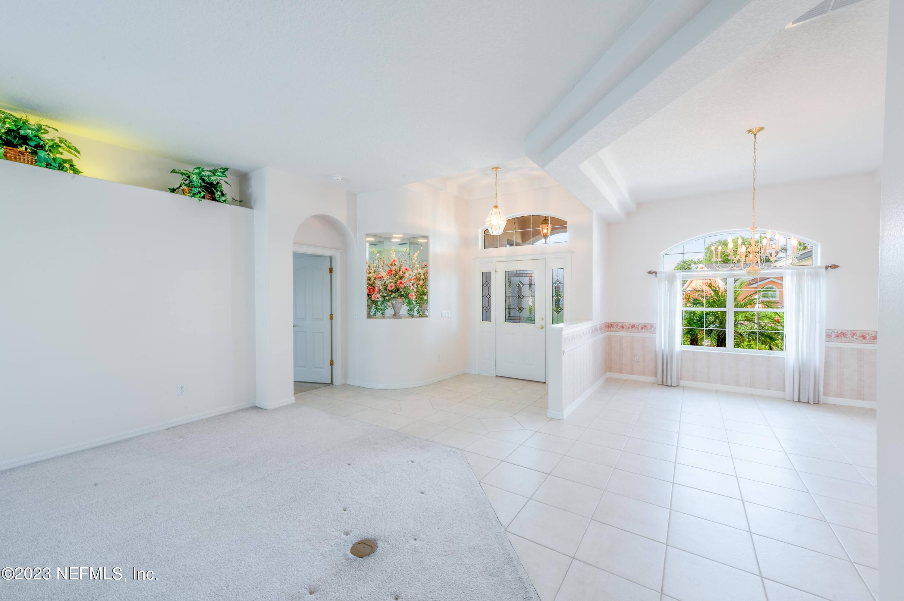 13 Clear Court Palm Coast, FL 32137 - Photo 27 of 60 an empty room with windows and outdoor view