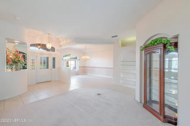 a bathroom with bathtub and window