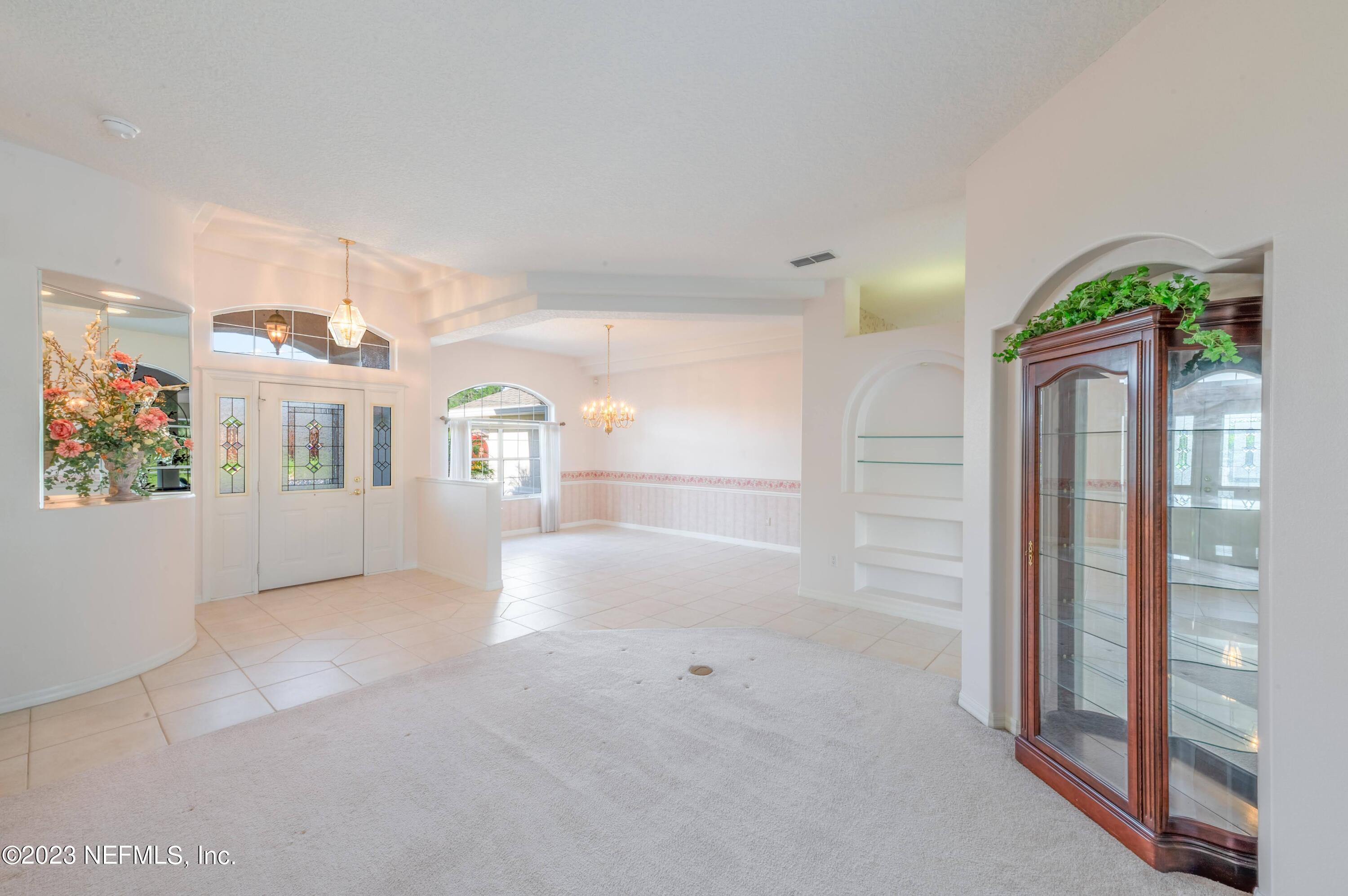 13 Clear Court Palm Coast, FL 32137 - Photo 28 of 60 a view of livingroom with furniture and staircase