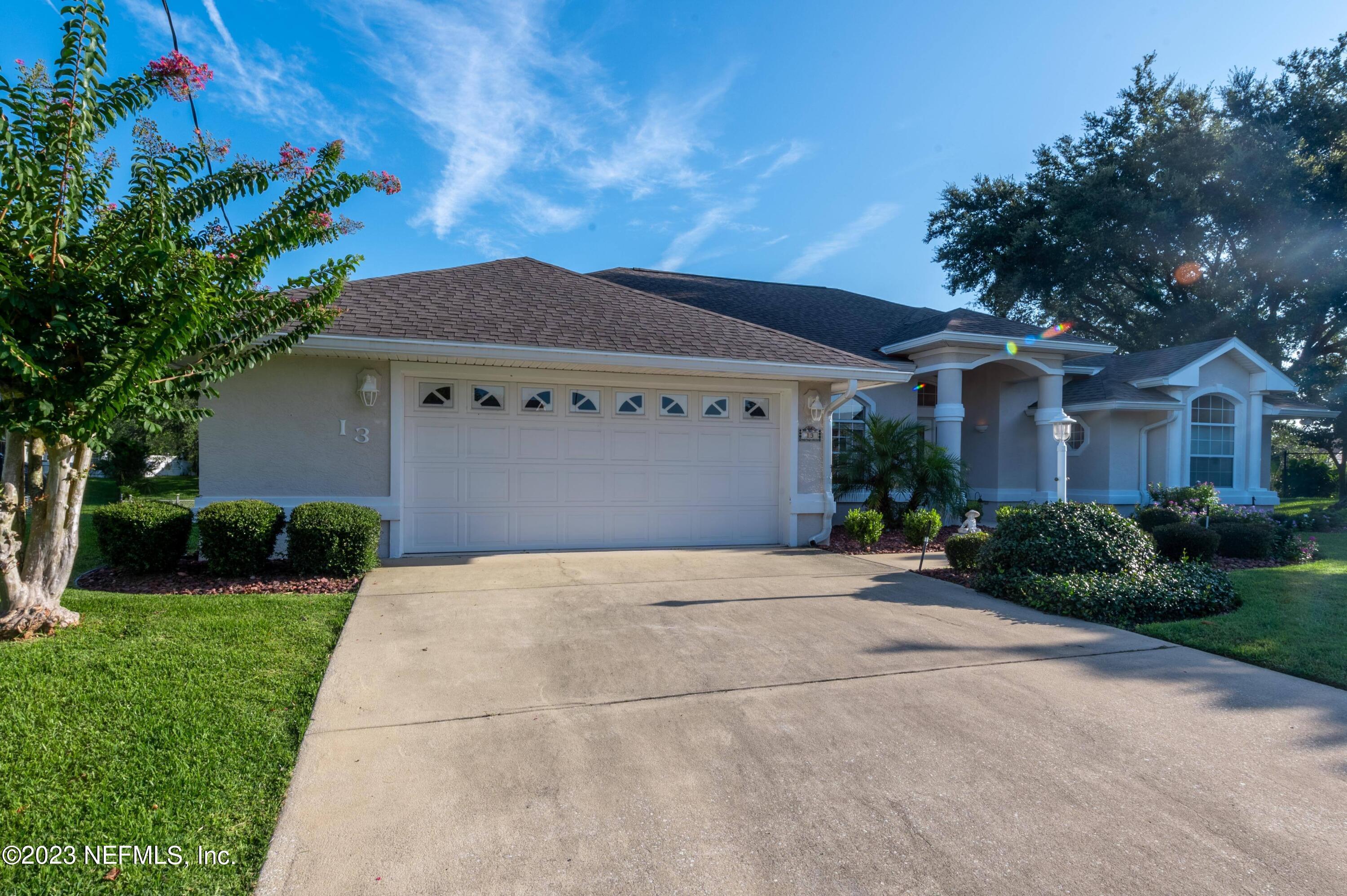13 Clear Court Palm Coast, FL 32137 - Photo 3 of 60 a front view of a house with a yard