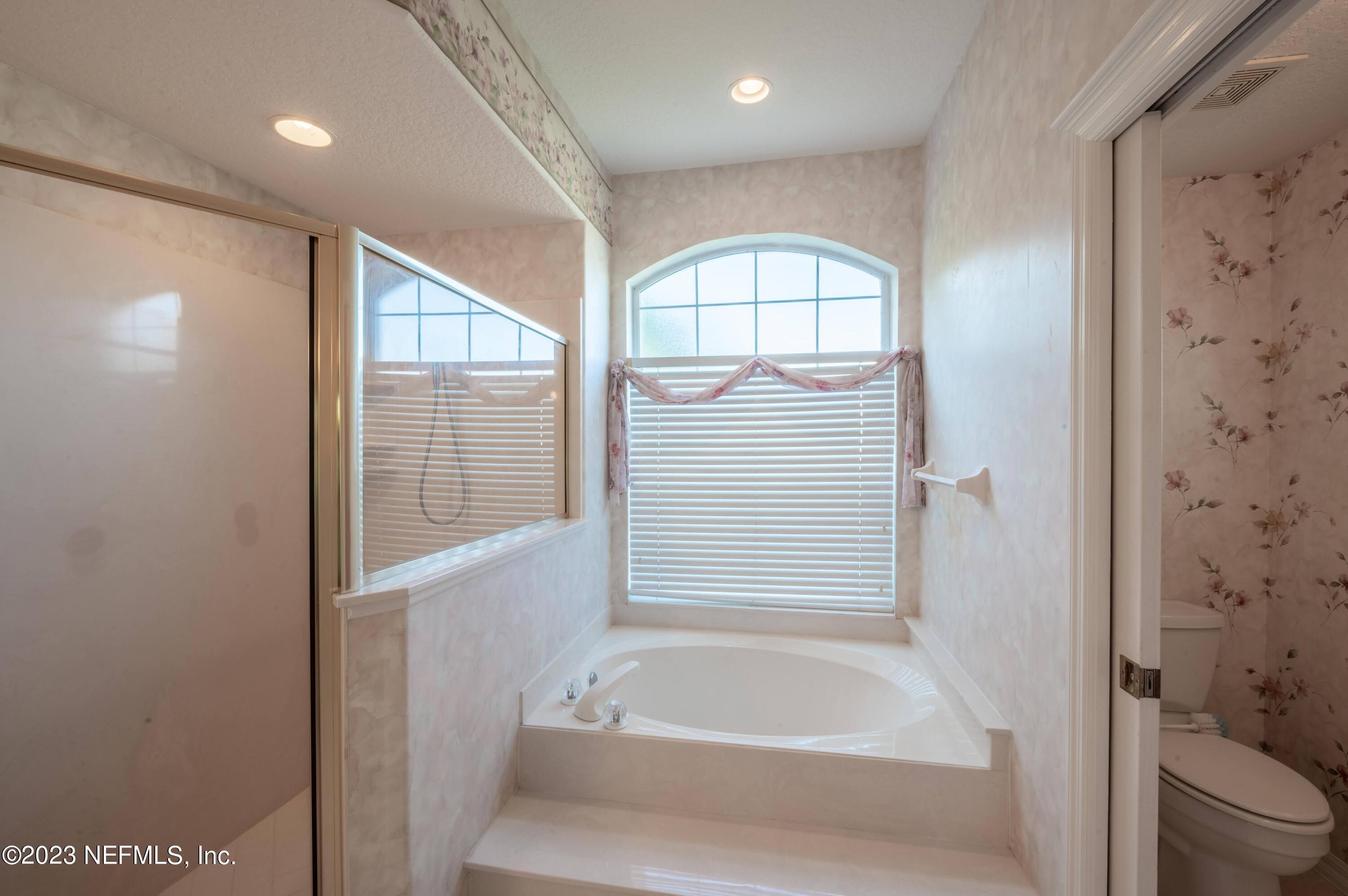 13 Clear Court Palm Coast, FL 32137 - Photo 34 of 60 a bathroom with a bathtub and a shower