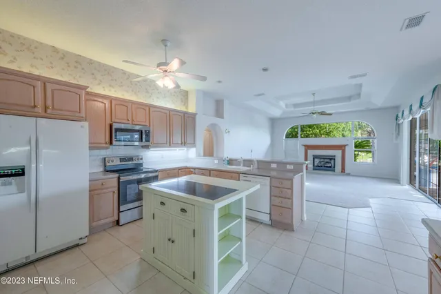 a view of a livingroom with a ceiling fan and window