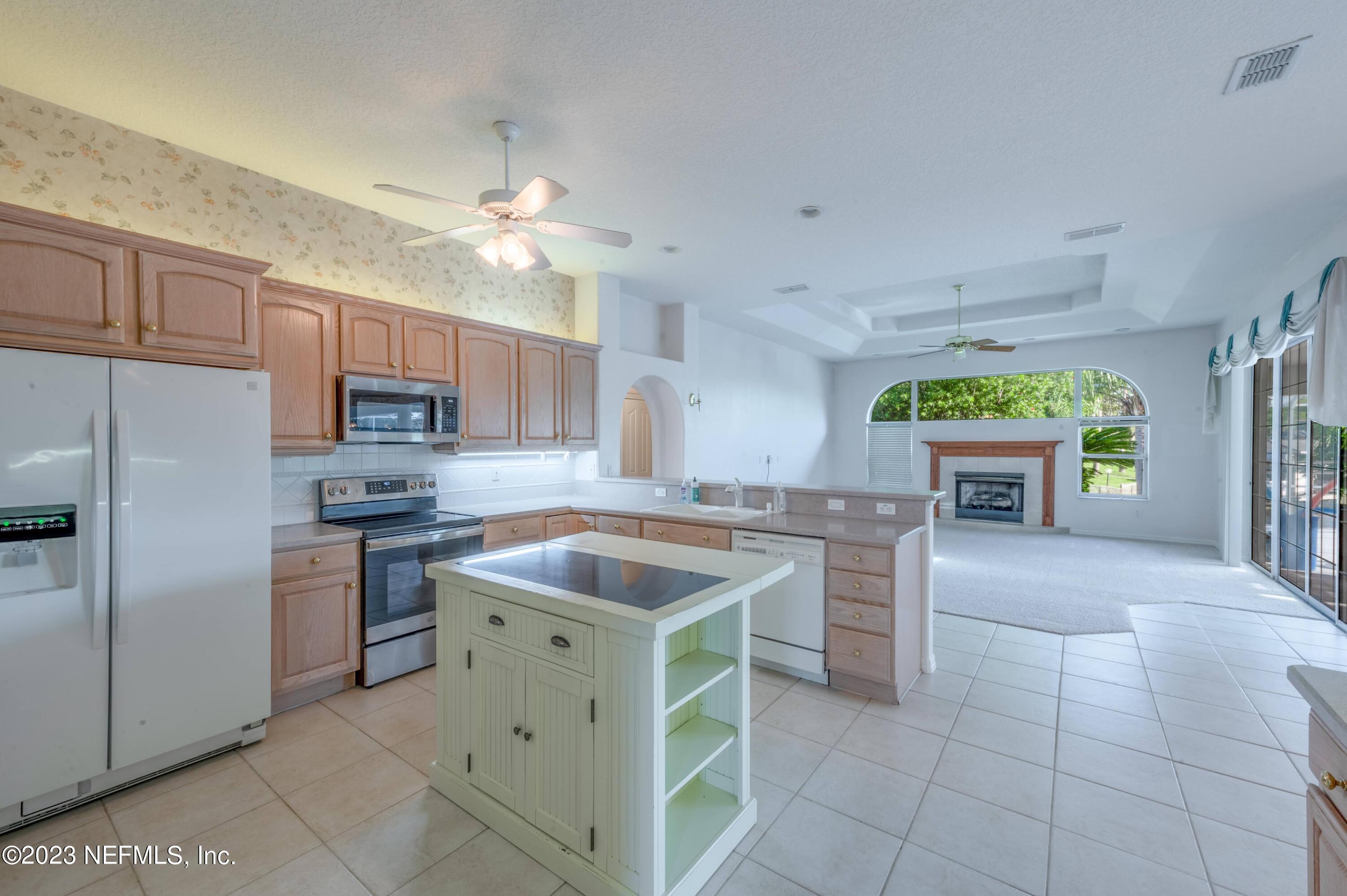 13 Clear Court Palm Coast, FL 32137 - Photo 42 of 60 a kitchen with a stove a refrigerator and a sink