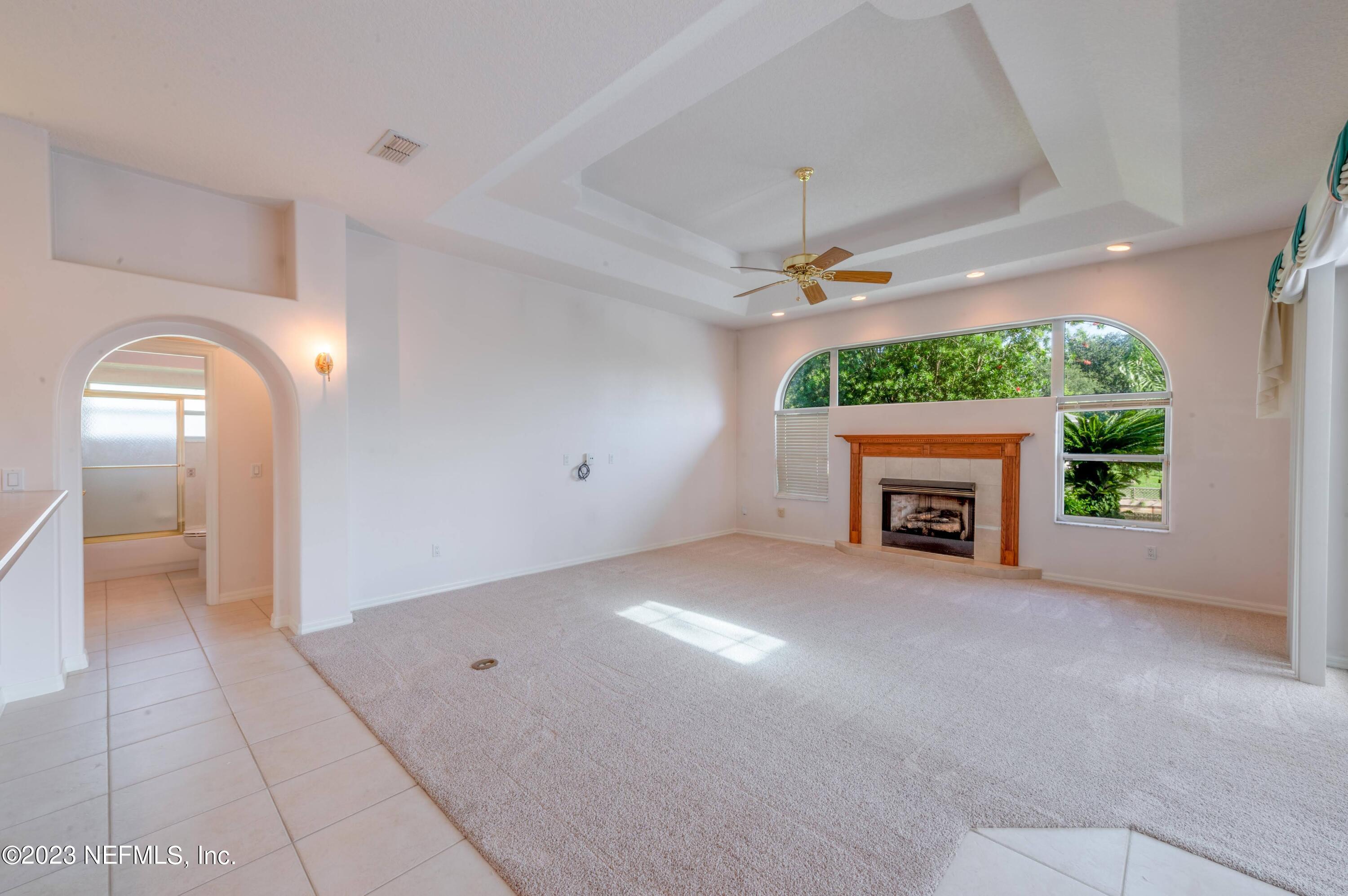 13 Clear Court Palm Coast, FL 32137 - Photo 51 of 60 an empty room with windows a fireplace and a fireplace