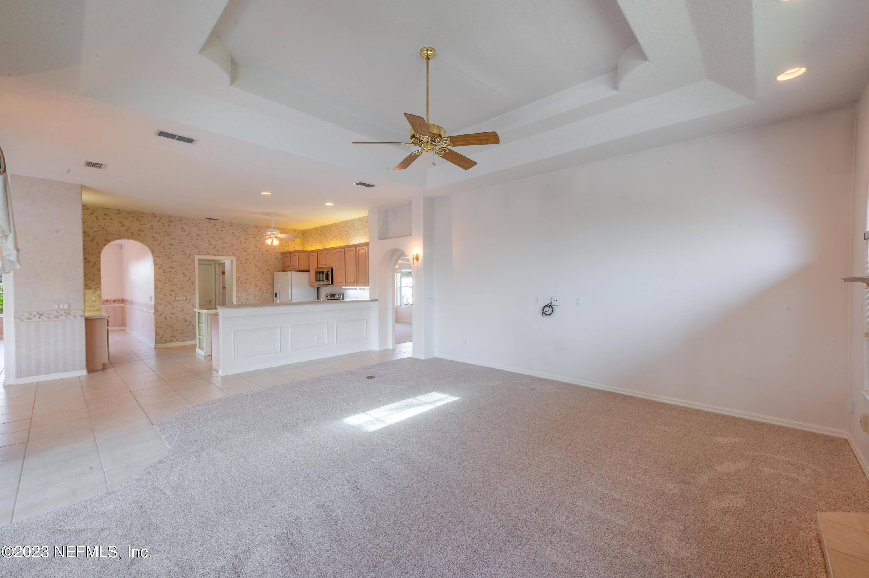 13 Clear Court Palm Coast, FL 32137 - Photo 52 of 60 a view of a livingroom with a ceiling fan and window