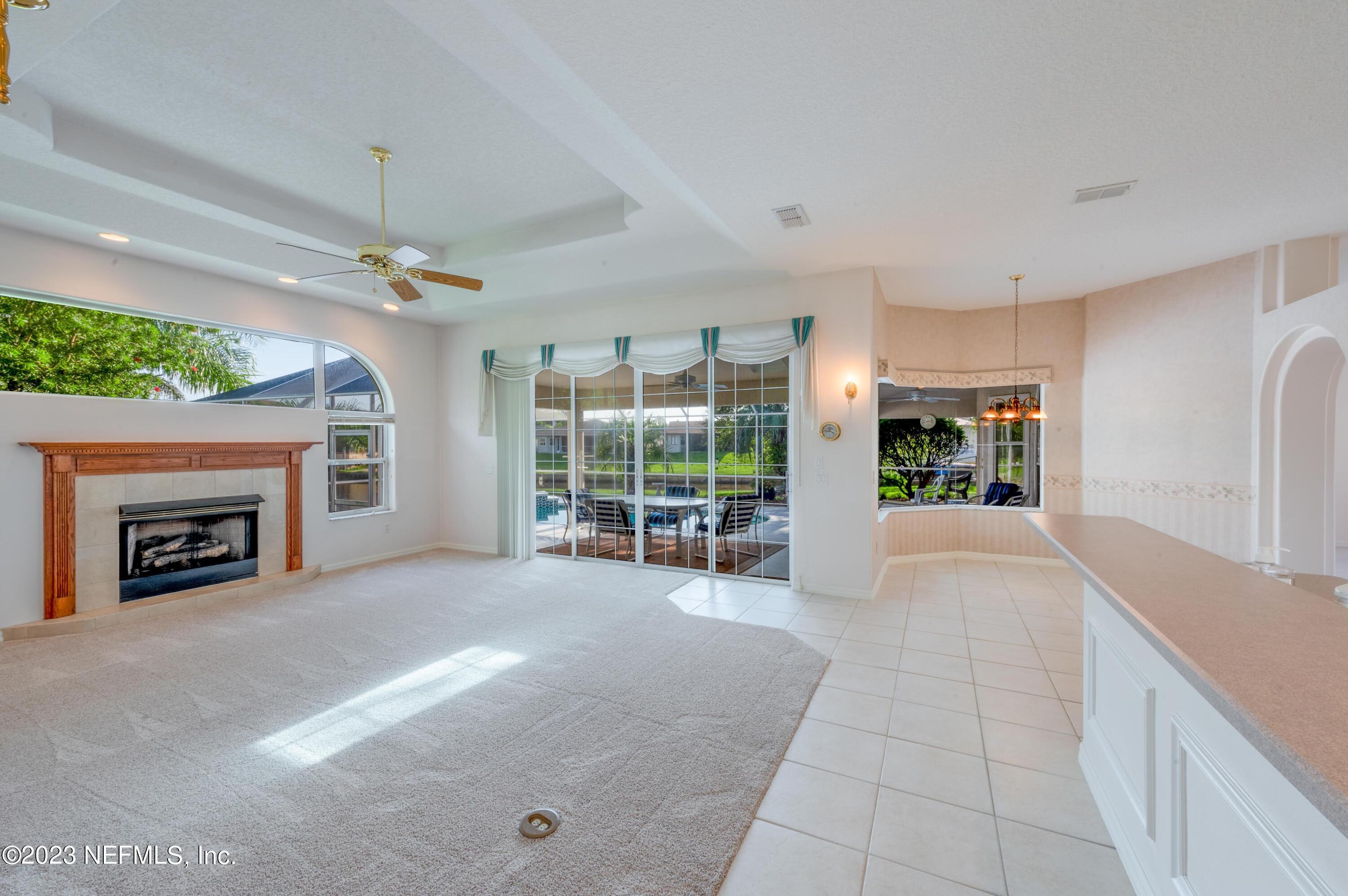 13 Clear Court Palm Coast, FL 32137 - Photo 54 of 60 a view of livingroom with furniture fireplace and window