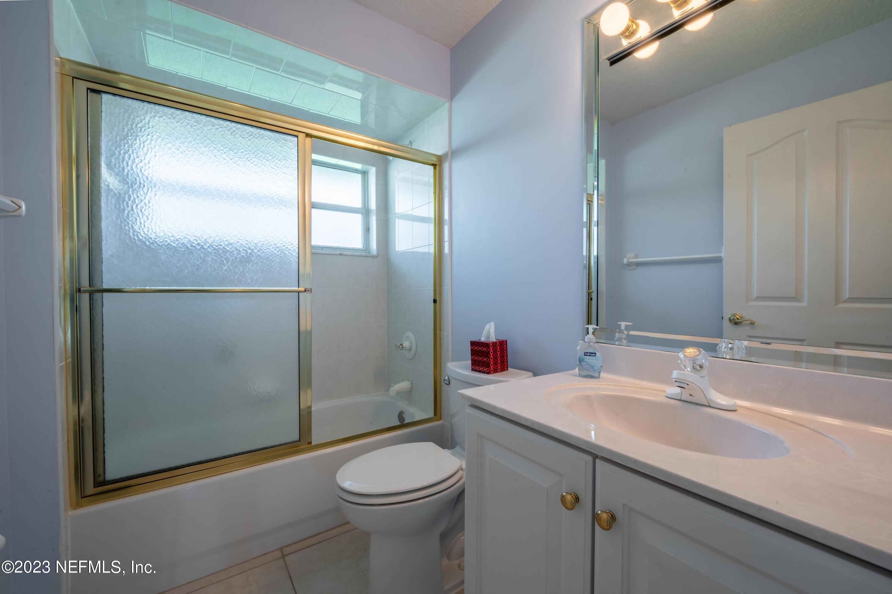 13 Clear Court Palm Coast, FL 32137 - Photo 58 of 60 a bathroom with a sink a toilet and shower