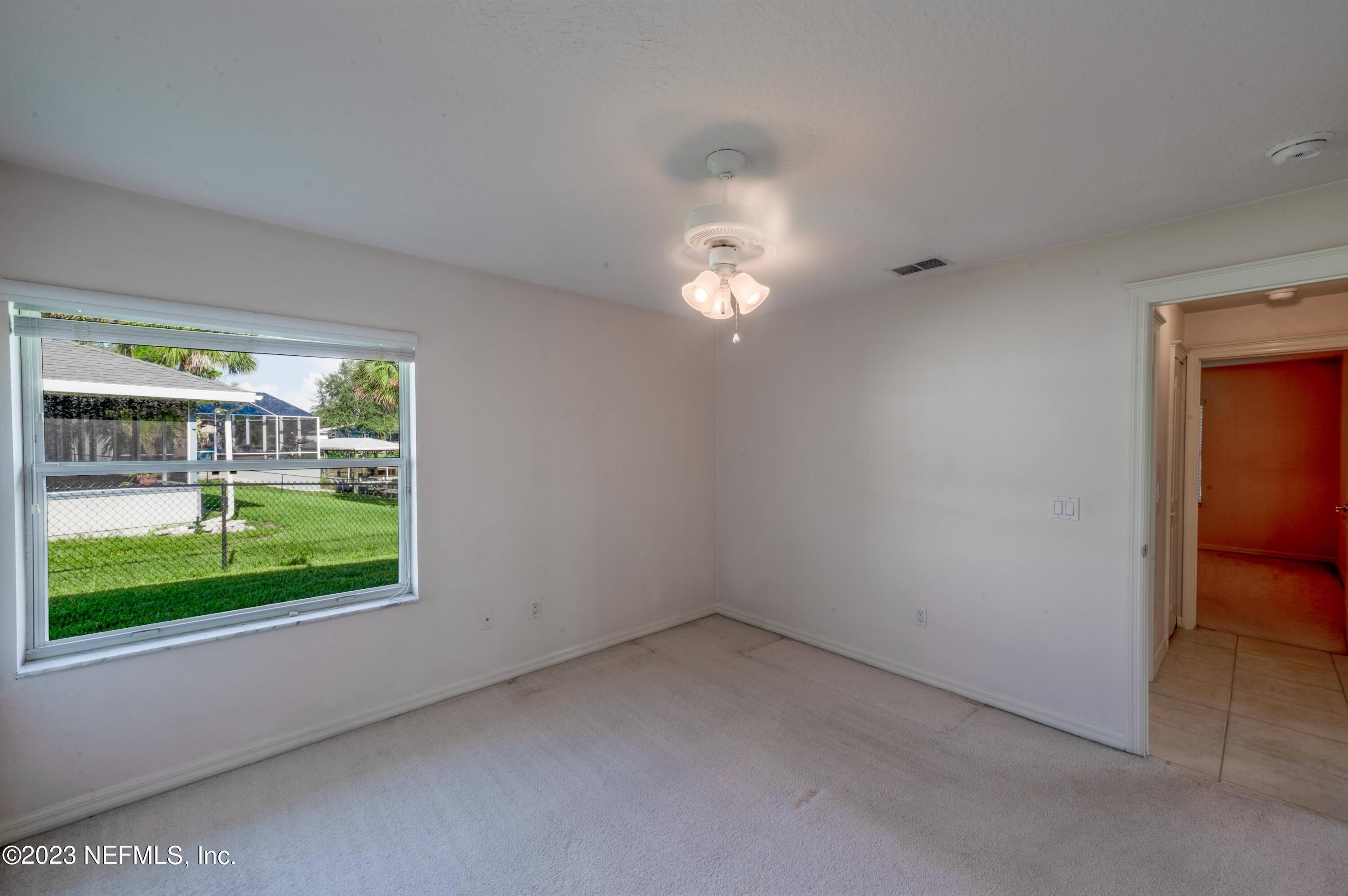 13 Clear Court Palm Coast, FL 32137 - Photo 60 of 60 wooden floor in an empty room with a window