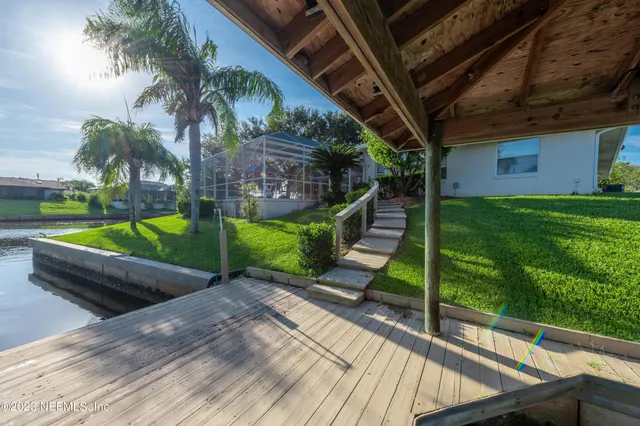 a view of backyard with swimming pool and patio