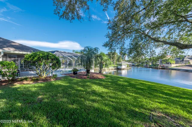a view of a backyard with swimming pool