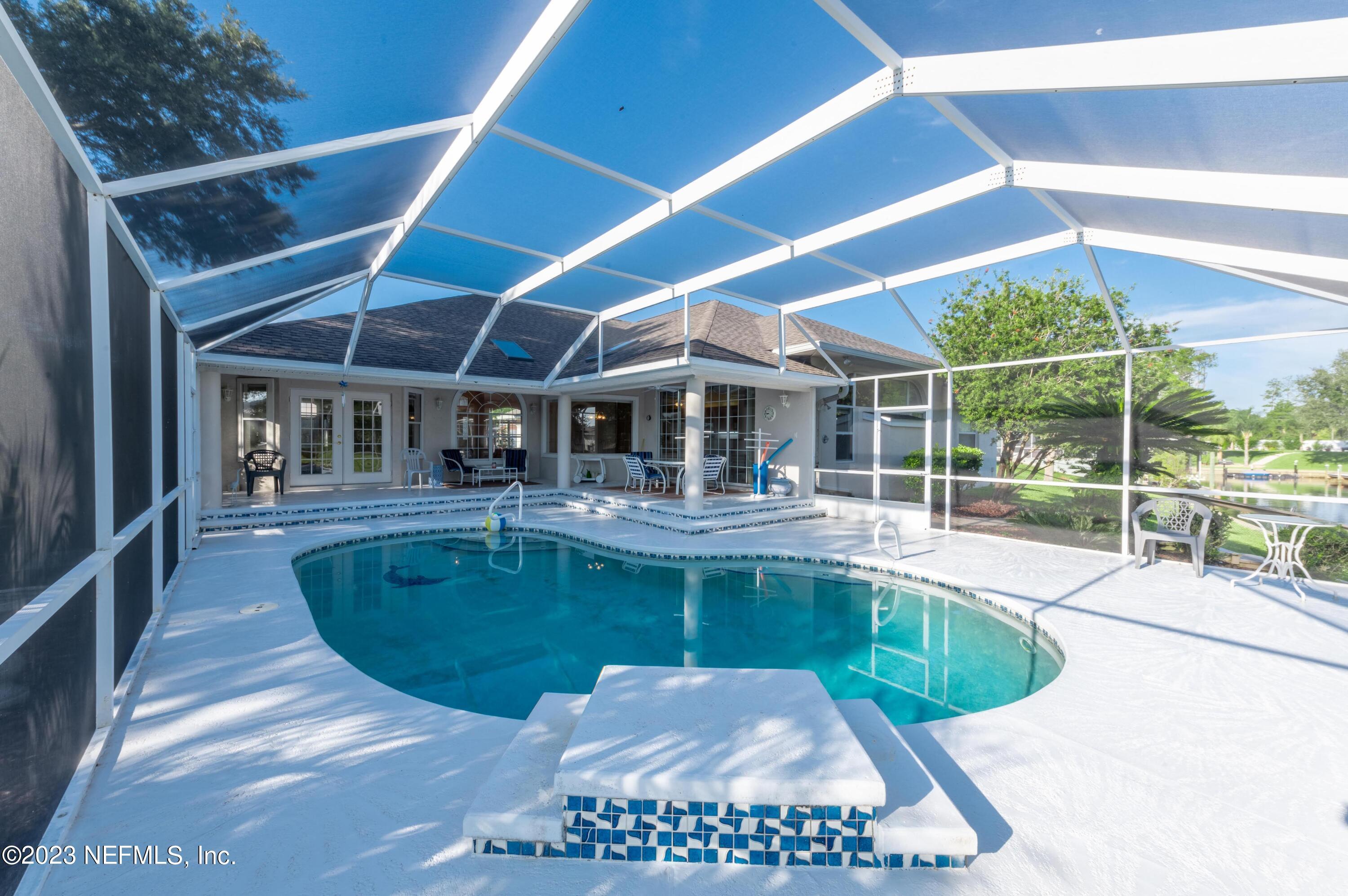 13 Clear Court Palm Coast, FL 32137 - Photo 10 of 60 a view of a swimming pool with a patio