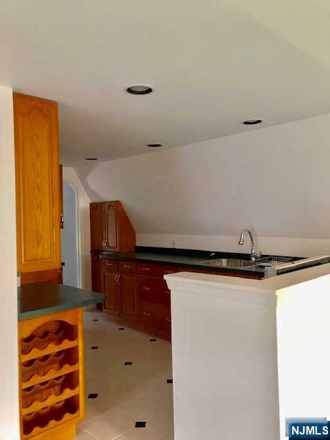 21 Columbus Street Bloomfield, NJ 07003 - Photo 14 of 20 a kitchen with a sink and a refrigerator