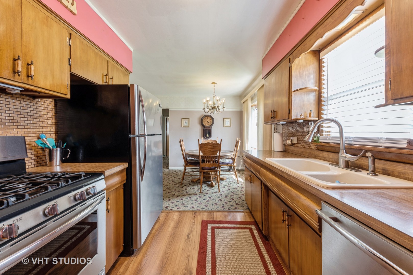 413 Village Road Willowbrook, IL 60527 - Photo 10 of 11 a kitchen with a sink stove and refrigerator