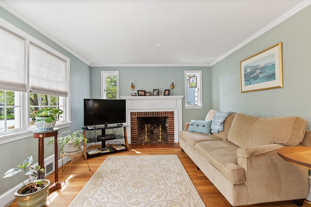 427 Main Street Hingham, MA 02043 - Photo 18 of 42 a living room with furniture a fireplace and a flat screen tv