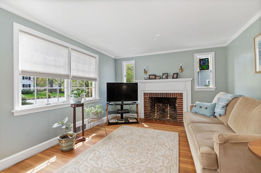 427 Main Street Hingham, MA 02043 - Photo 19 of 42 a living room with furniture a fireplace and a flat screen tv