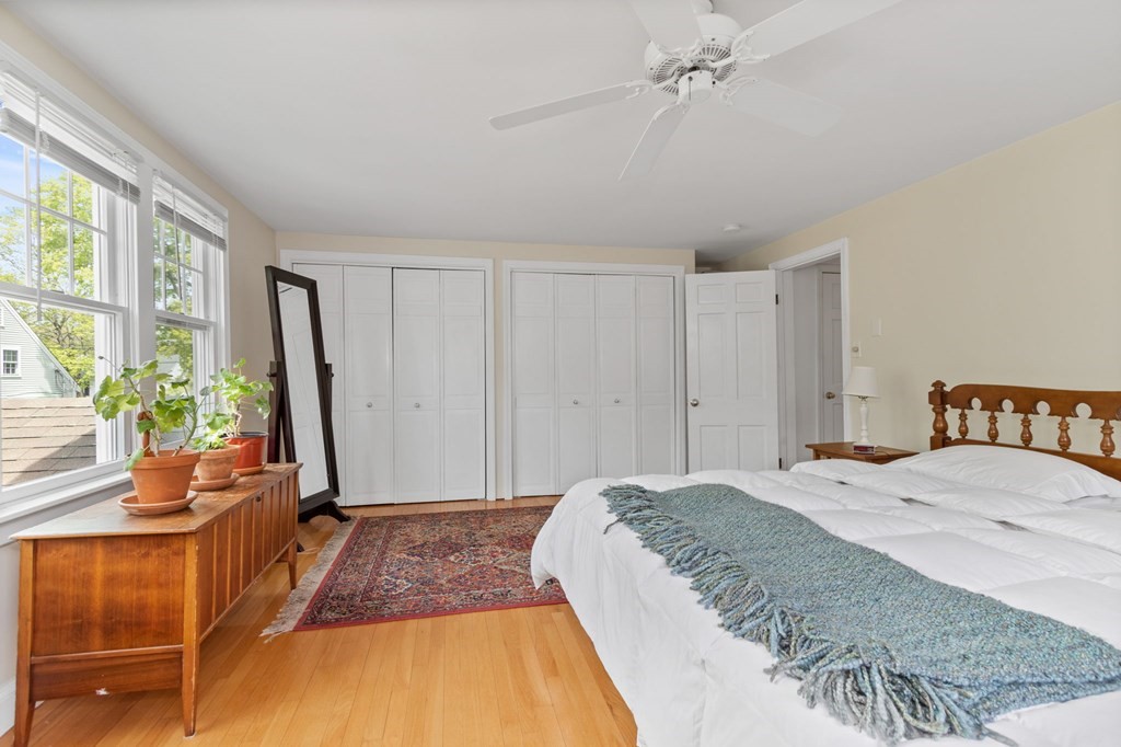 427 Main Street Hingham, MA 02043 - Photo 26 of 42 a spacious bedroom with a bed and a potted plant
