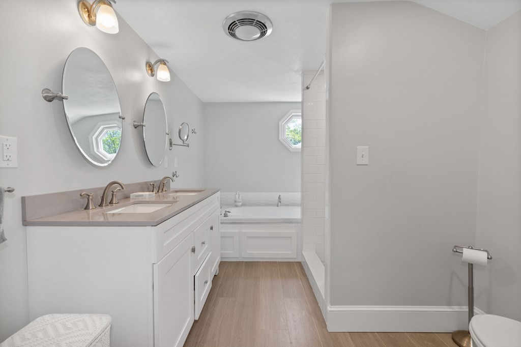 427 Main Street Hingham, MA 02043 - Photo 27 of 42 a bathroom with a double vanity sink and a mirror