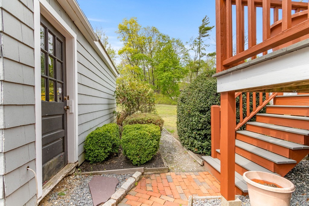 427 Main Street Hingham, MA 02043 - Photo 35 of 42 a view of a pathway of a house with potted plants