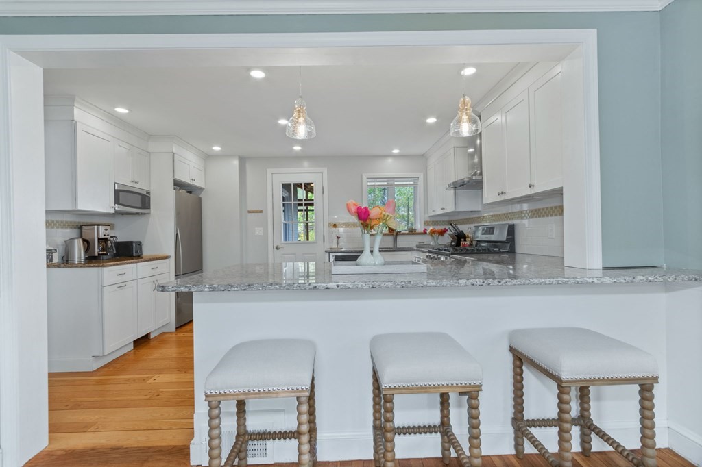 427 Main Street Hingham, MA 02043 - Photo 4 of 42 a kitchen with stainless steel appliances granite countertop a sink and cabinets