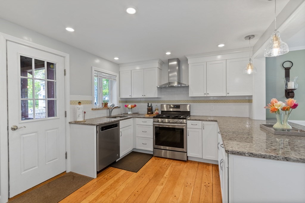 427 Main Street Hingham, MA 02043 - Photo 7 of 42 a kitchen with stainless steel appliances granite countertop a sink stove and refrigerator