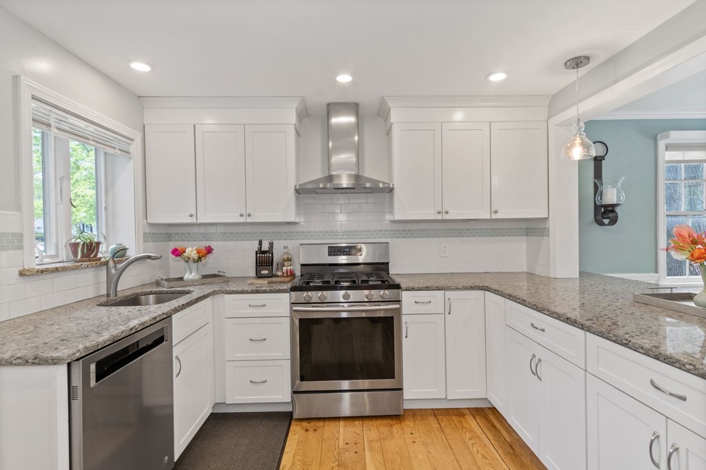 427 Main Street Hingham, MA 02043 - Photo 8 of 42 a kitchen with granite countertop white cabinets and white stainless steel appliances