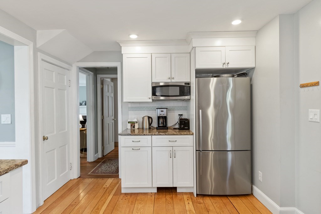 427 Main Street Hingham, MA 02043 - Photo 9 of 42 a kitchen with stainless steel appliances a refrigerator and a stove top oven
