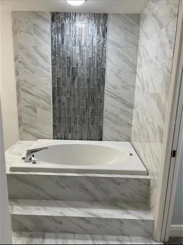 a bathroom with a bathtub and shower