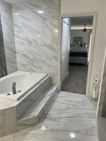 a bathroom with a tub and shower