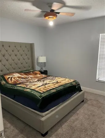 a bedroom with bed and window