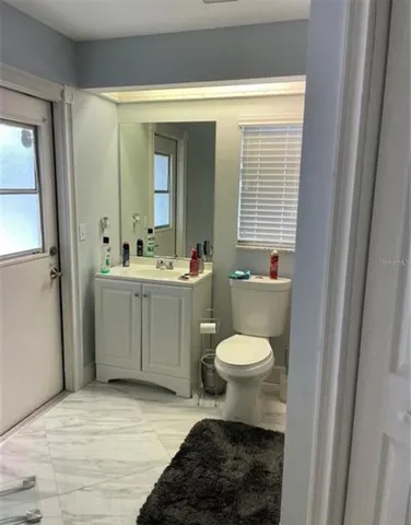 a bathroom with a toilet sink and mirror