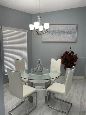 a dining room with furniture and chandelier
