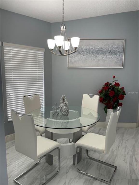 6125 Mariner Boulevard Spring Hill, FL 34608 - Photo 8 of 24 a dining room with furniture and chandelier