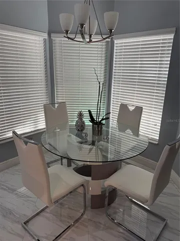 a view of a dining room with furniture and window