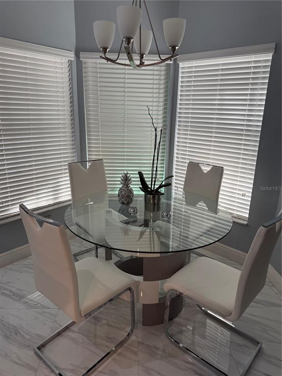 6125 Mariner Boulevard Spring Hill, FL 34608 - Photo 9 of 24 a view of a dining room with furniture and window