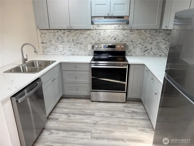a kitchen with a sink stove and cabinets