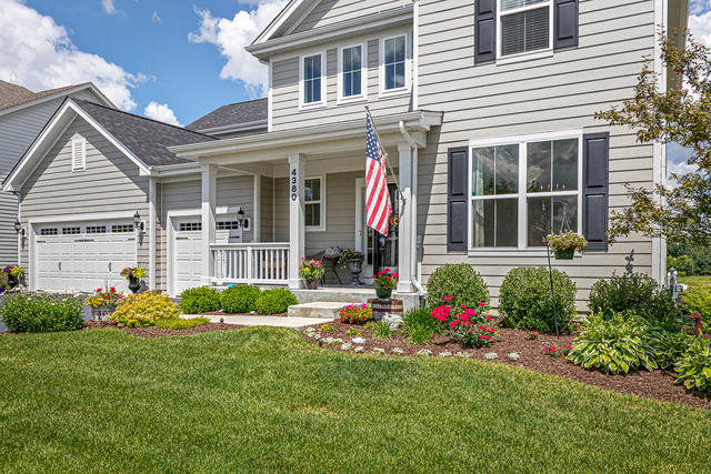 4380 John Milton Road Elgin, IL 60124 - Photo 2 of 30 a front view of a house with a yard and porch