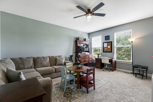 4380 John Milton Road Elgin, IL 60124 - Photo 12 of 30 a living room with furniture and a large window