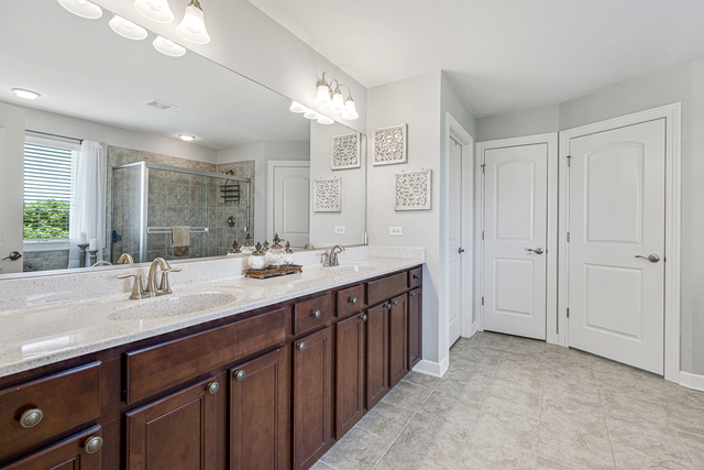 4380 John Milton Road Elgin, IL 60124 - Photo 17 of 30 a spacious bathroom with double vanity and a mirror