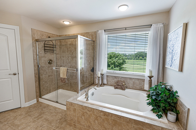4380 John Milton Road Elgin, IL 60124 - Photo 18 of 30 a bathroom with a bathtub and shower