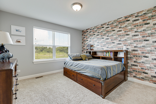 4380 John Milton Road Elgin, IL 60124 - Photo 23 of 30 a bed sitting in a bedroom next to a window