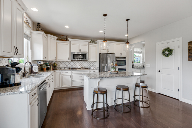 4380 John Milton Road Elgin, IL 60124 - Photo 7 of 30 a kitchen with stainless steel appliances granite countertop a stove top oven a refrigerator a sink and white cabinets with wooden floor